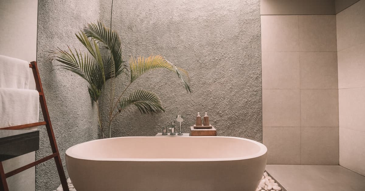 Trendy modern bathroom with natural materials and statement lighting