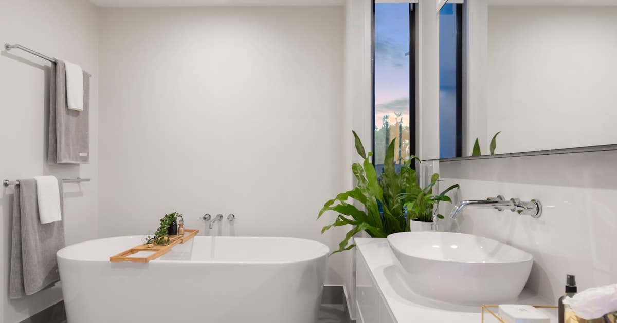 Elegant walk-in shower with frameless glass door and rainfall showerhead